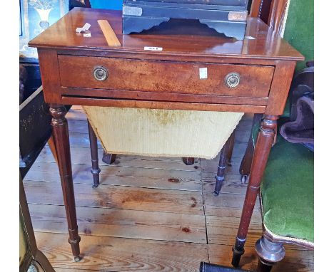 A 23" late Georgian mahogany sewing table with long frieze drawer and slide out tapered work draw, set on turned and tapered 