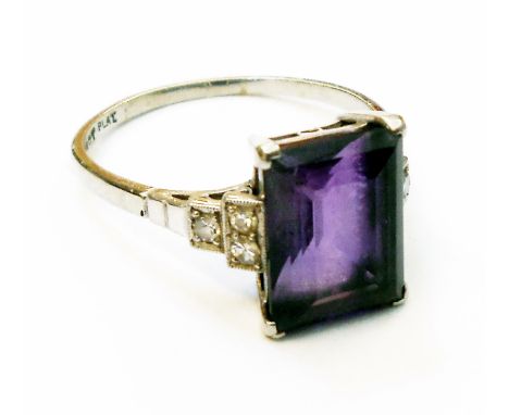 A marked 18/Plat Art Deco ring set with large central emerald cut amethyst with tiny diamonds to stepped shoulders - shank wo