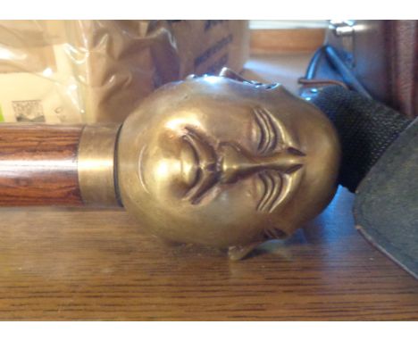 A modern reproduction walking stick with four faced Buddha top