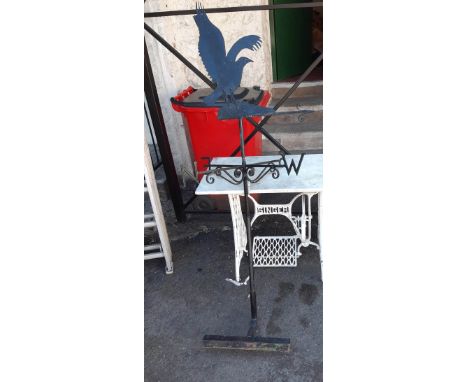 A large weather vane with crow pattern finial