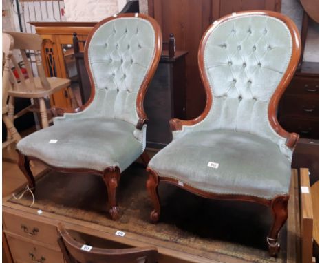 A pair of reproduction Victorian style mahogany part show frame spoon back nursing chairs with green velour button back uphol