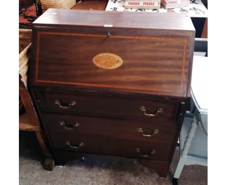 A 30" Edwardian inlaid mahogany bureau with shell motif to fall and fitted interior over three long graduated drawers, set ra