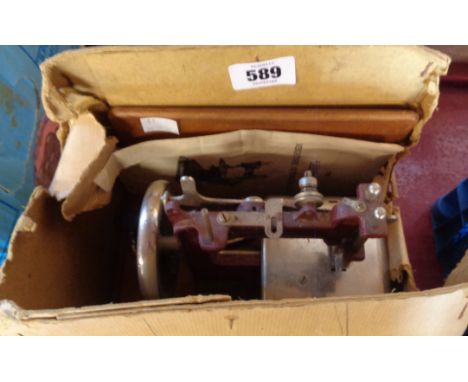 A vintage Astor child's sewing machine in remains of box