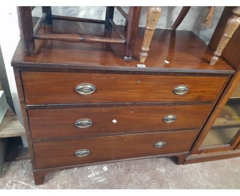 A 3' 6" 19th Century mahogany chest of three long graduated drawers with embossed thistle back plate handles, set on bracket 