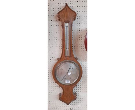 An early 20th Century polished oak cased banjo barometer/thermometer with silvered style dial marked for Heitzman &amp; Sons,