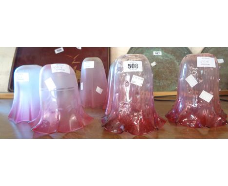 Seven assorted cranberry glass lamp shades including a pair of Edwardian shades