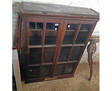 A 3' 3 1/2" antique stained oak book cabinet with pigeon-hole and shelf fitted interior enclosed by a pair of glazed panel do