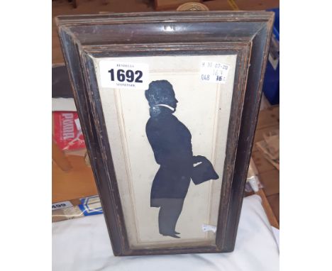 A framed 19th Century silhouette full length portrait of a gentleman holding a top hat - bearing name of artist and subject v