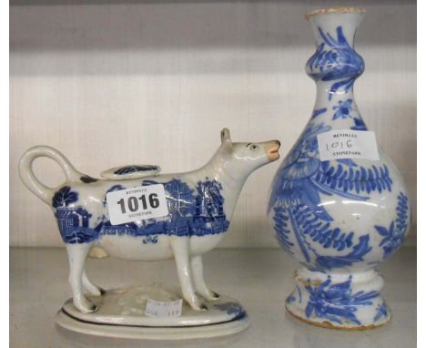 An 18th Century delftware vase - sold with an early 19th Century pearl ware blue and white Willow pattern cow creamer