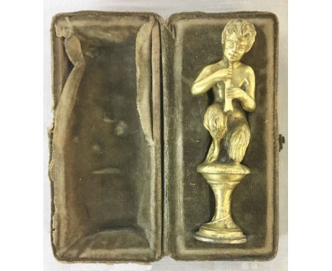 A late 19th Century leather cased finely cast brass pipe tamper modelled as Pan