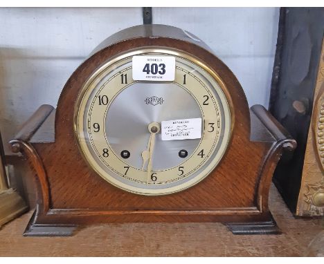 A vintage Garrard polished oak cased mantel clock with scroll sides and eight day gong striking movement 