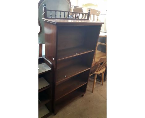 A 29" Edwardian mahogany and mixed wood four shelf open bookcase with spindle top rail and adjustable shelves, set on turned 