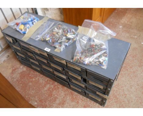 A metal multi-drawer tool chest containing a large quantity of transistors