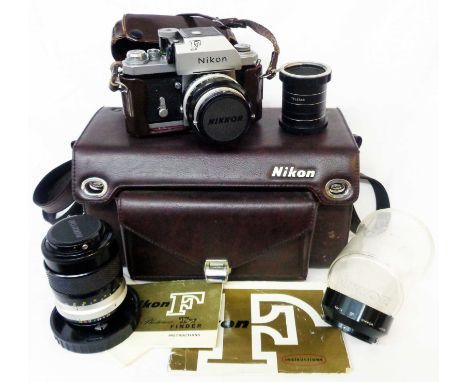 A Nikon F camera body with Nikkor 50mm 1.4 lens, 135mm 2.8 telescopic lens and case