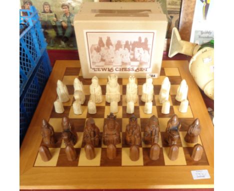 A vintage boxed set of Lewis chessmen by Petrushkin games and associated board