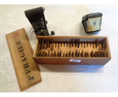 A vintage boxed brass stencil set - sold with a travelling alarm clock and a Kodak vest pocket camera