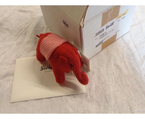 A Steiff red felt elephant model number 035814 complete with original tags, retailer box and envelope - limited edition 37/20