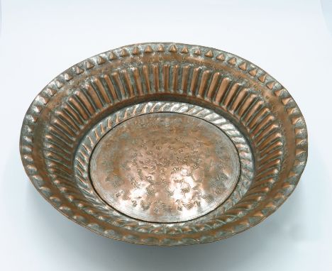 An Islamic tinned copper basin, late 19th/early 20th century with stamped and fluted decoration, diameter 41cm, together with