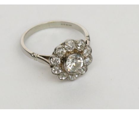 A good 18ct white gold diamond cluster ring, the central stone of approximately 1ct spread surrounded by ten smaller diamonds