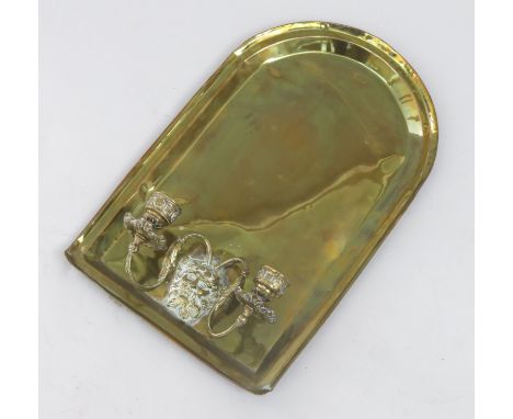 An Edwardian brass wall bracket, of plain arched form with twin candle sconces and lion mask mount, height 36cm.