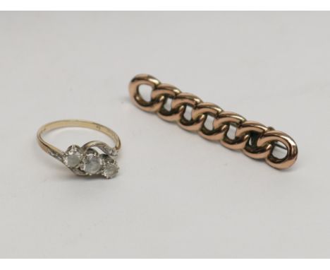 A gold brooch and a crossover ring, together with a Garrad box.