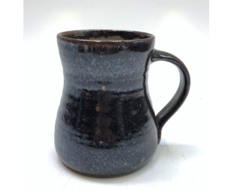 A Michael Leach Yelland pottery mug, of waisted form, brown glazed, height 13cm.
