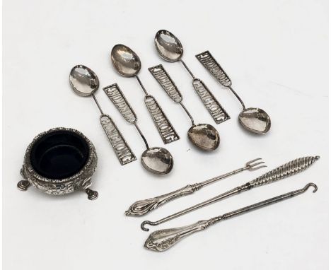 A Georgian silver open salt on three hoof feet and with embossed floral decoration, two button hooks with filled silver handl