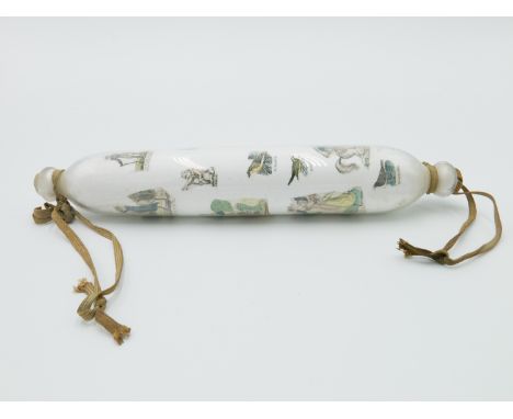 A Victorian Decalcomania glass rolling pin, with inset coloured printed images on a white ground, length 34cm.