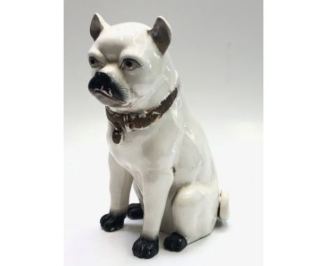 A continental ceramic model of a seated pug dog, circa 1900, height 36cm. 