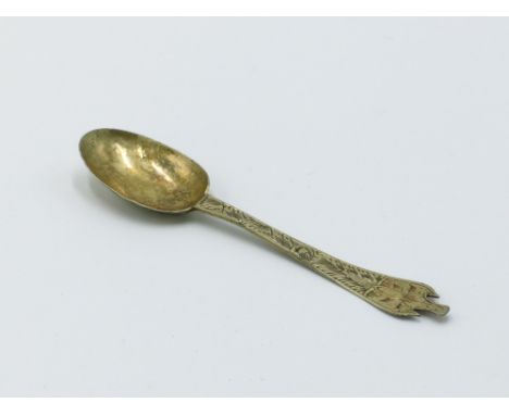A Charles II silver gilt small trefid finial spoon the flat stem engraved to the front and back, the bowl back engraved and w