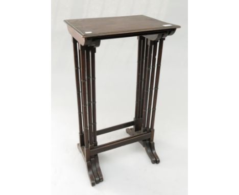 A nest of three mahogany tables, on ring turned legs, height 88cm, width 44cm.