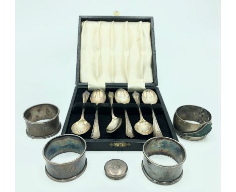 A cased set of six silver coffee spoons together with a silver napkin ring with green enamelled leaf decoration, three other 