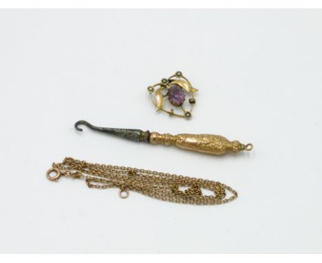 A small late Victorian gold mounted button hook hall marked Birmingham 1898 and an Art Nouveau gold pendant set in amethyst o