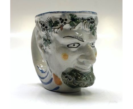 An English pearlware satyr jug, early 19th century, decorated in Pratt enamel, height 9cm.