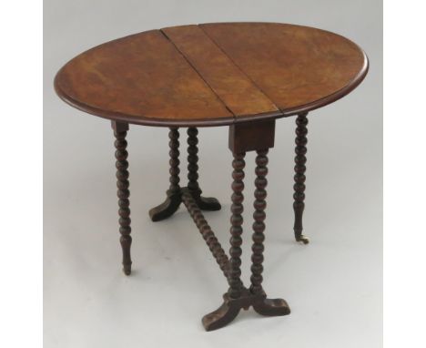 A Victorian burr walnut Sutherland table, the oval top on bobbin turned legs, height 59cm, length 60cm.  Condition report: Lo