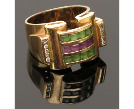 An 18ct gold 1950's styled ring with bands of amethyst and green stones between diamond line shoulders.