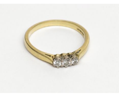 An 18ct gold ring set three diamonds. Condition report: Total weight 4.1g.