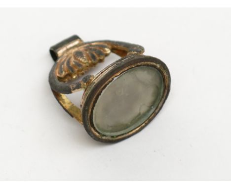 A gilt metal seal with an intaglio portrait of George lll.