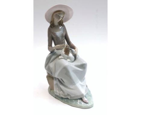 A Lladro figure of a lady, seated with a puppy on her lap, height 34cm.