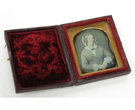 A small Daguerreotype portrait of a seated lady, cased.
