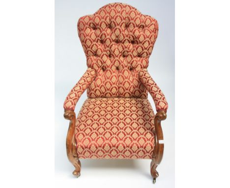 A Victorian walnut gentleman's armchair, with a shaped button upholstered back, padded arms and seat, on cabriole legs, heigh