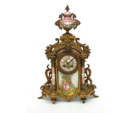 A French gilt metal and porcelain mounted mantel clock, with urn finial, Sevres style pink ground panels and column side supp