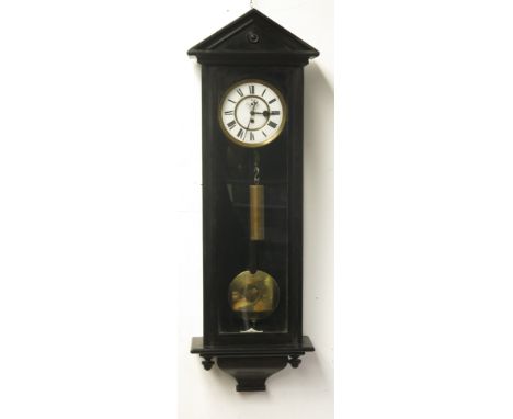 A Vienna regulator wall clock, in ebonised case with architectural arched pediment, circular white enamel dial with single we