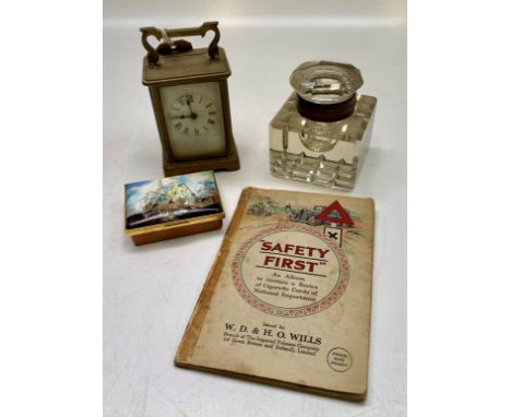 A carriage clock, a large cut glass inkwell, a Halcyon Days snuff box and an album of cigarette cards.