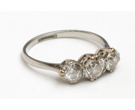 A good three stone diamond ring set in platinum, the central stone of approximately 0.65ct spread.