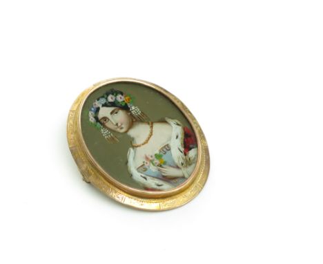 A 19th century gold mounted brooch with a heightened portrait of a lady, possibly Queen Victoria.