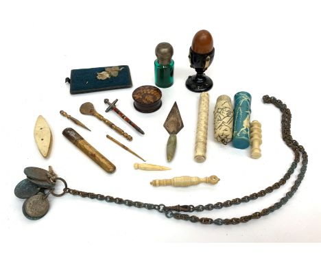 A silver (unmarked) trowel bookmark with green striated stone handle, a gilt steel bodkin case and other needlework implement