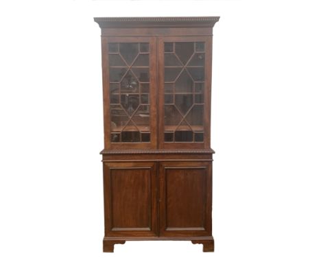 A mahogany bookcase, 19th century, the pair of astragal glazed doors above a pair of panelled doors on bracket feet, 190 x 92