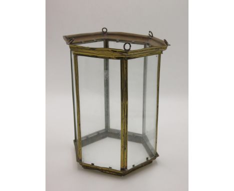 A brass hexagonal hanging lantern, early 20th century, with six glazed rectangular panels, height 29cm. 