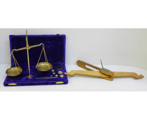 A set of balance scales and weights and a gilt brass section of balance scales 